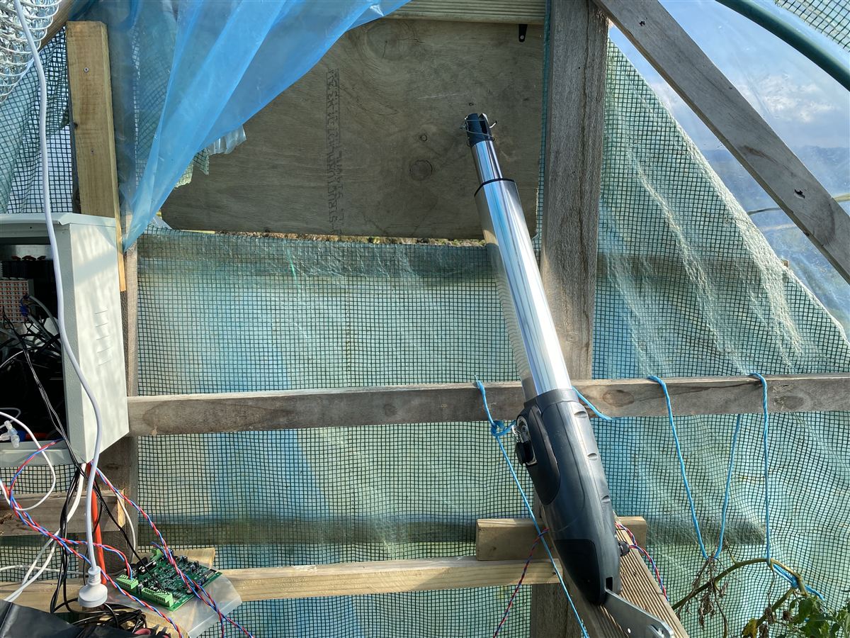 24V linear actuator mounted on the hoop house end wall